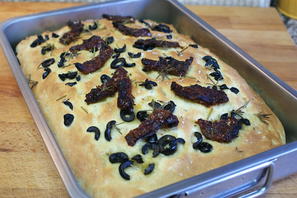Focaccia italiana con tomates secos, aceitunas negras y romero fresco